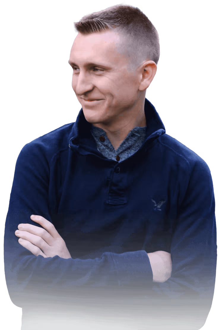 Image of Titus smiling with his arms crossed.